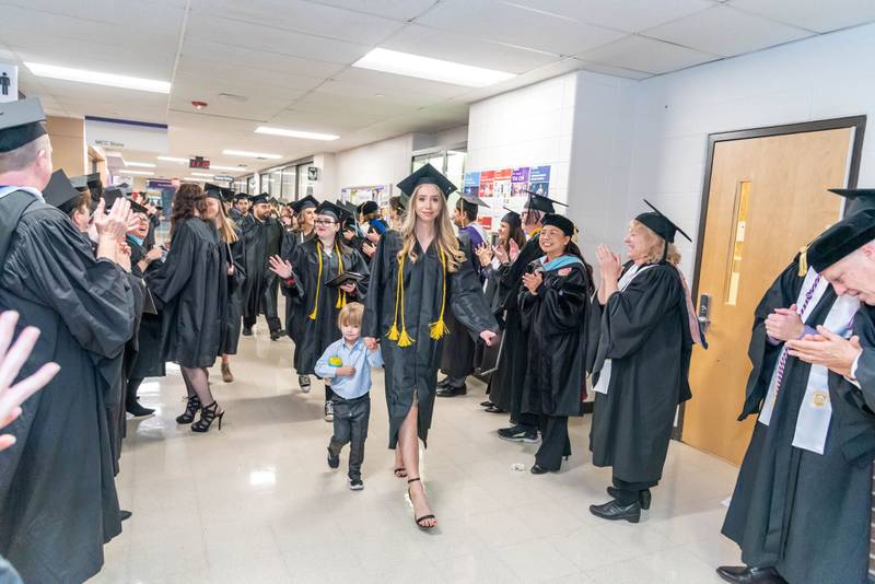 Graduates are applauded by McHenry County College faculty and staff after Saturday’s commencement ceremony on Saturday, Dec. 10, 2022.