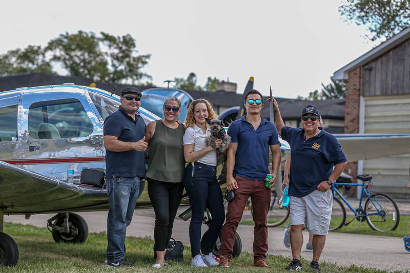 Edmndo Aillon (right) poses with guests in front of his 1964 Piper Cherokee 140 at the Brookeridge Airport Fly in.  Sept 10, 2022.