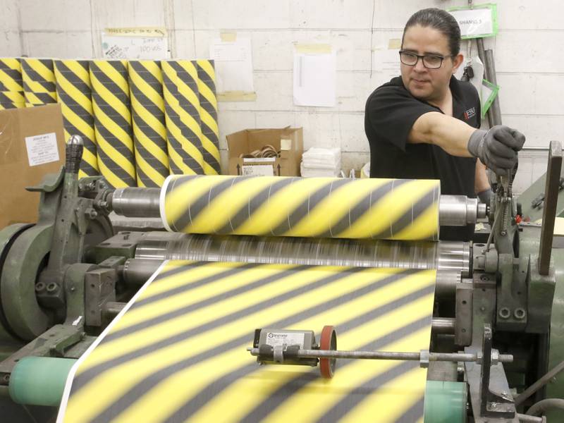Miguel Benitez runs a machine that makes smaller rolls of safety tape on Wednesday, March 1, 2023, at Jessup Manufacturing Co. In February, Jessup was named as one of the Top 50 companies of 2023 by Digital Output Magazine, partly because of its unique products.