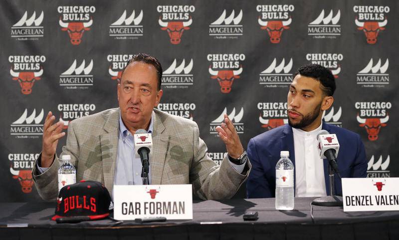 Chicago Bulls general manager Gar Forman, left, talks about the talent of Denzel Valentine, right, the Bulls' first round draft pick during an NBA basketball news conference Monday, June 27, 2016, in Chicago.