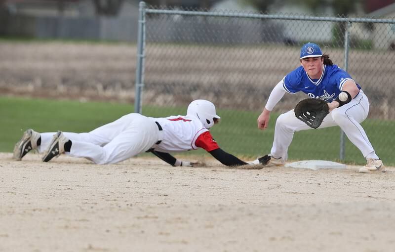 Indian Creek's Kason Murry dives back into first base as Hinckley-Big Rock's Martin Ledbetter takes the throw during their game Monday, May 1, 2023, at Indian Creek High School in Shabbona.