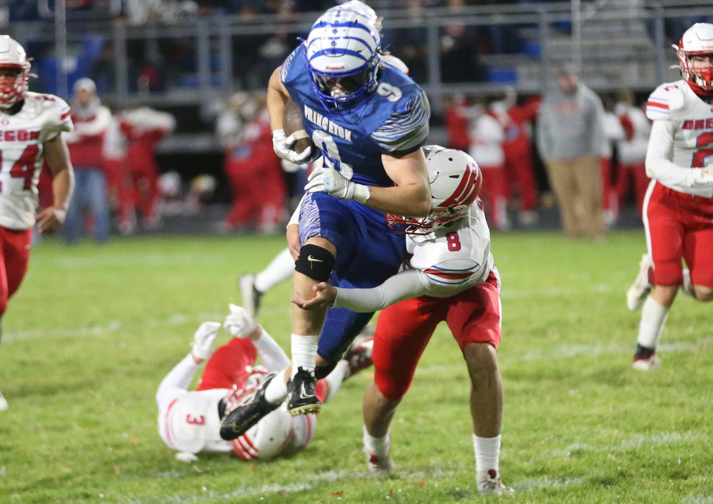Princeton's Arthur Burden attemps to break free of Oregon defender Jakobi Donegan during the Class 3A playoff game on Friday, Nov. 1, 2024 at Princeton High School.