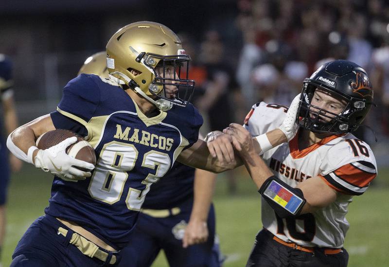 Polo’s Mercer Mumford stiff arms Milledgeville’s Caleb Sarber Friday, Sept. 19, 2025.