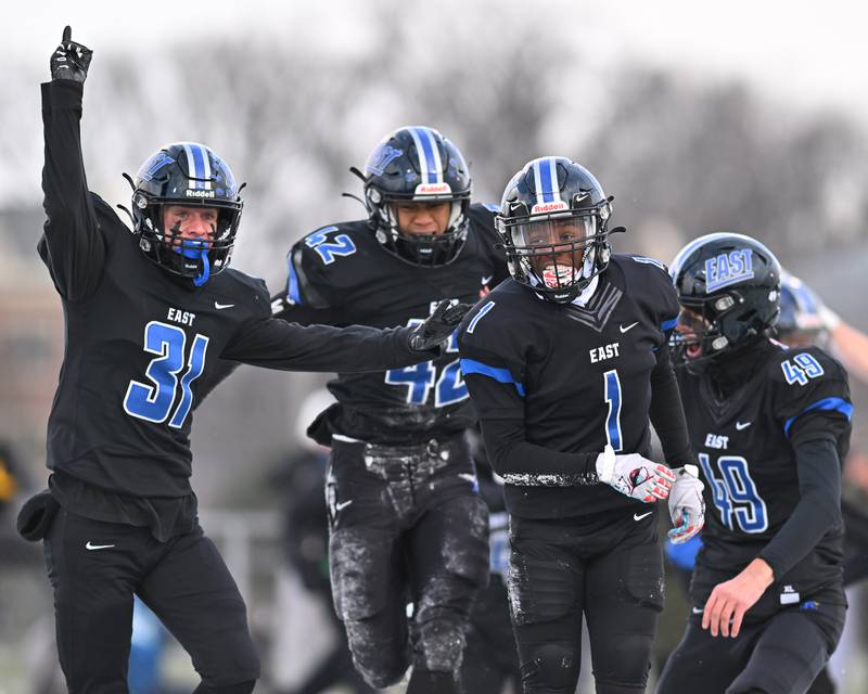 Lincoln-Way East's teammates celebrate after making a big play during the IHSA Class 8A Semifinals on Saturday, November 19, 2022, at Frankfort.