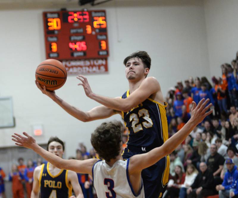 Polo's Noah Dewey (23) shoots as Eastland's Tanner Stern (3) tries to draw the charge on Friday, Feb. 23, 2024 during the 1A Forreston Regional championship game at Forreston High School.