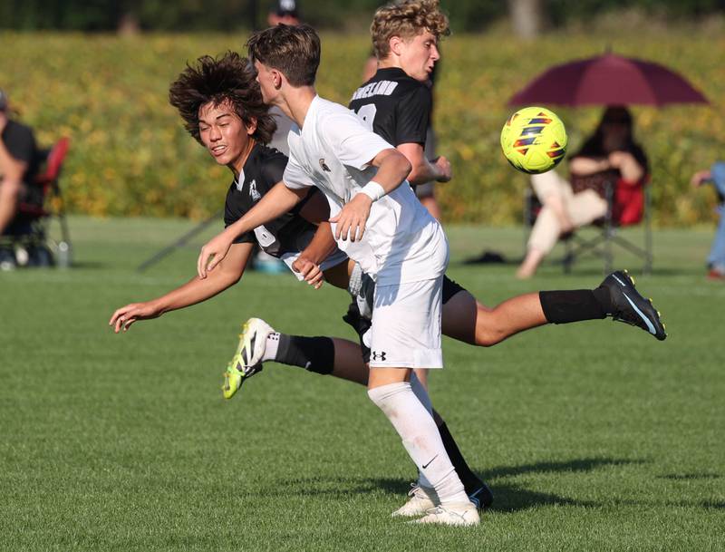 Kaneland's Dylan Pilz (left) and Sycamore's Andre Crouch get tangled up going after the ball during their game Wednesday, Sept. 16, 2025, at Kaneland High School in Maple Park.