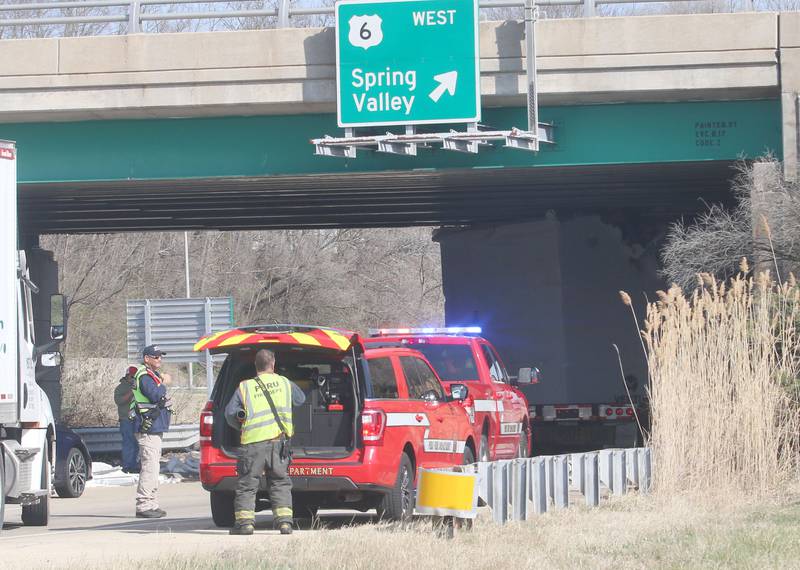 Peru firefighters work the scene of a semi truck that struck the U.S. Route 6 overpass on Monday, March 30, 2026 in Peru. Traffic was closed in both northbound and southbound directions on Illinios Route 251. Peru Police and Fire were on the scene. The incident happened shortly before 10a.m.