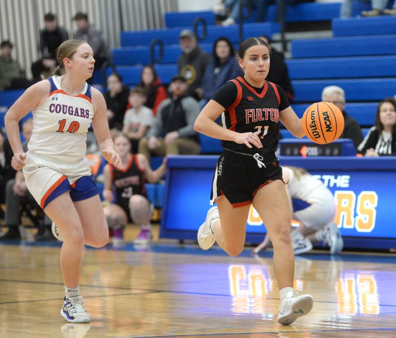 Fulton's Zoe Kunau (21) brings the ball up the court as Eastland's Izzy Ames (10) follows during a Friday, Dec. 13, 2024 game at Eastland High School in Lanark.
