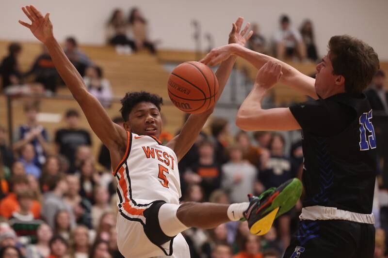 Lincoln-Way West’s Daniel Reniguntala draws the foul by Lincoln-Way East’s Brayden Lovell.