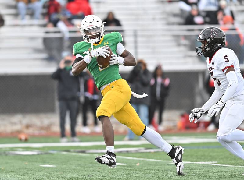 Providence Catholic's Xavier Coleman (2) catches a pass over Springfield's Davonte Brown (5) during the class 5A first round playoff game on Saturday, NOV. 01, 2025, at New Lenox.