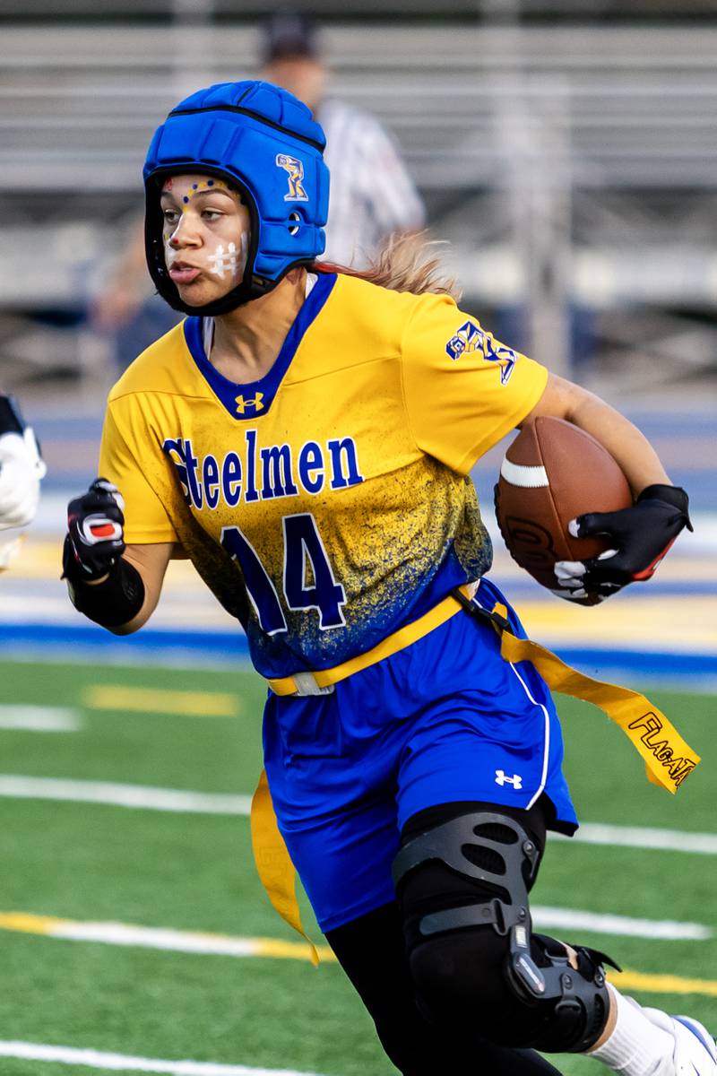 Joliet Central's Elliana Fowler picks-up some yards during a varsity flag football home game against Bloom on Sept. 11, 2025.