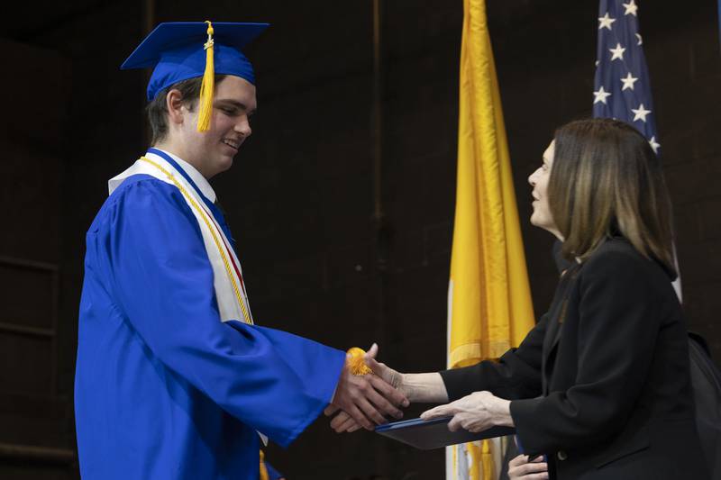 Kazimieras Grazulis accepts his diploma Wednesday, May 21, 2025, during Newman High School’s 2025 commencement.