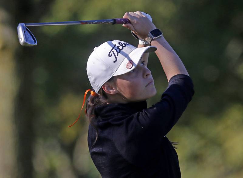 McHenry’s Kilynn Axelson watches her tee shot on the 11th hole during the Fox Valley Conference Girls Golf Tournament Wednesday, Sept. 25, 2024, at Crystal Woods Golf Club in Woodstock.