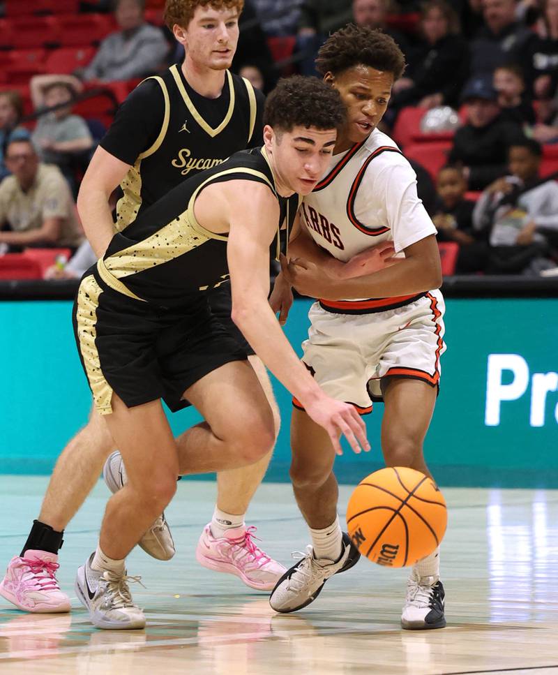 Sycamore's Marcus Johnson (left) and DeKalb's Bryan Miller go after a loose ball Friday, Jan. 30, 2026, during the FNBO Challenge at the Convocation Center at Northern Illinois University in DeKalb.