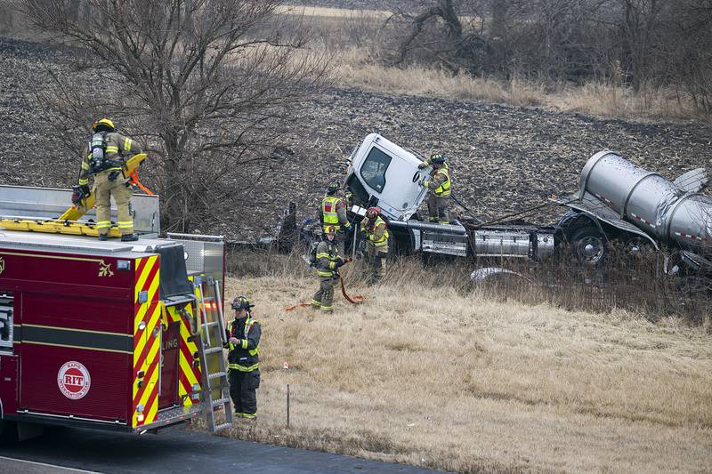 Firefighters work to free the driver of a semi that left the roadway on Interstate 88 on Monday, Feb. 3, 2025, between Dixon and Rock Falls.