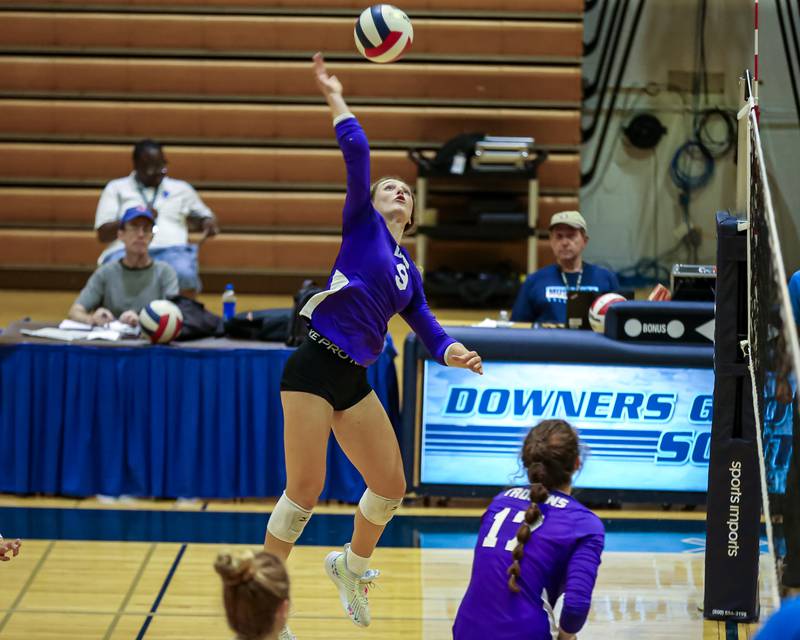 Downers Grove North's Kelley Crowley (9) smashes the ball over the net during volleyball match between Downers Grove North at Downers Grove South.  Sept 7, 2023.