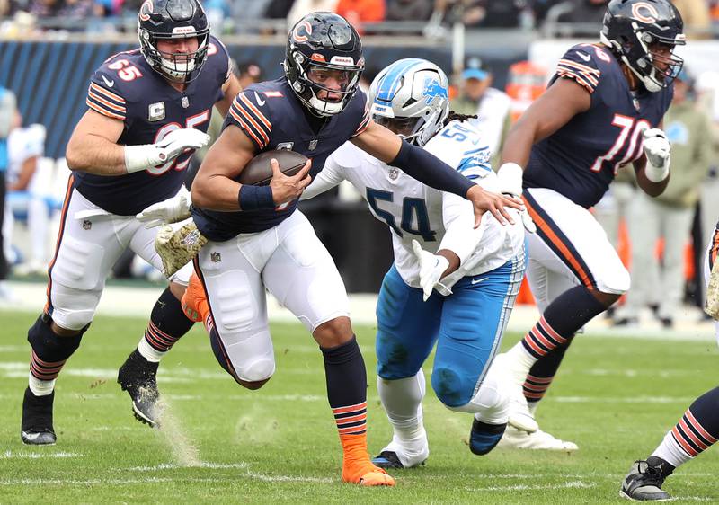 Chicago Bears quarterback Justin Fields breaks through the Lions defensive line during their game Sunday, Nov. 13, 2022, at Soldier Field in Chicago.