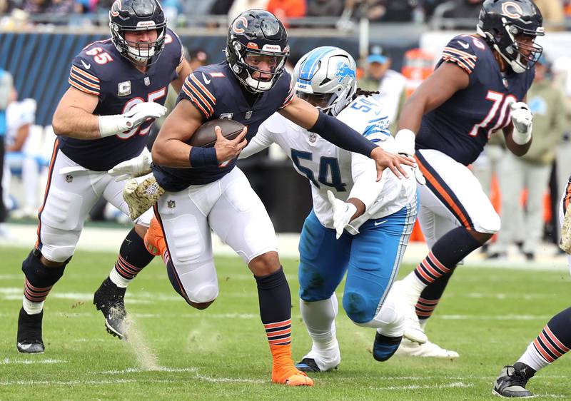 Chicago Bears quarterback Justin Fields breaks through the Lions defensive line during their game Sunday, Nov. 13, 2022, at Soldier Field in Chicago.