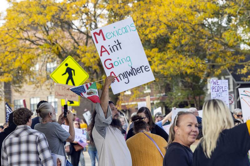 Cory Canas displays an anti-Trump sign Saturday, Oct. 18, 2025, during a “No Kings” rally in Sterling.