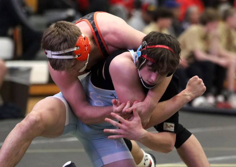 Marian’ Central's Josh Gawronski, front, battles Washington’s Wyatt Medlin at 165 pounds  in varsity boys wrestling on Thursday, Feb. 5, 2026, at Sycamore High School in Sycamore.