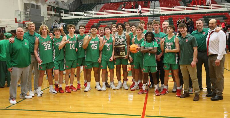 Members of the L-P boys basketball team pose with the Class 3A Regional title plaque after defeating Streator on Friday, Feb. 28, 2025 in Sellett Gymnasium at L-P High School.