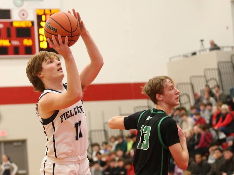 Fieldcrest's Nathan Cook eyes the basket while running into the lane past Rock Falls's Aydan Goff during the 49th annual Colmone Classic on Saturday, Dec. 9, 2023 at Hall High School.