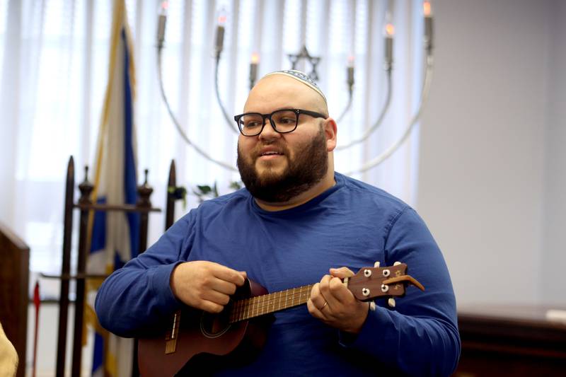 Alex Moliwell of Harvard plays a ukulele during a Chanukah party at The McHenry County Jewish Congregation Sunday.