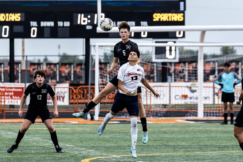 Minooka's Cayle Bomstad and Romeoville's Luiz Arazate fight for control of the ball during a varsity soccer game in Minooka on Sept. 23, 2025.