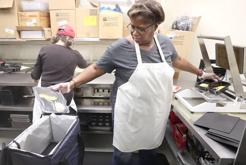 Bonita Gordon, a kitchen assistant at the Voluntary Action Center, prepares meals for delivery Thursday, Nov. 17, 2022, at the facility in Sycamore. VAC delivers meals to the homebound and elderly along with providing transportation options.