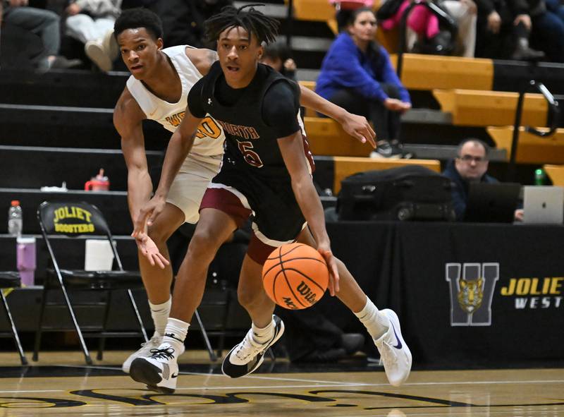 Plainfield North's Darin Ashiru (5) in action during a conference game against Joliet West on Friday, Dec. 20, 2024, at Joliet.