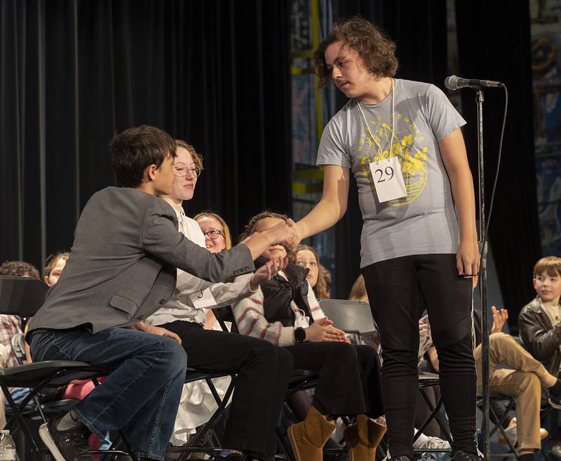 Fulton Unity Christian 8th grader Jake Bailey shakes hands with runner-up Prophetstown-Lyndon-Tampico 7th grader Jackson Melton Thursday, Feb. 21, 2024.