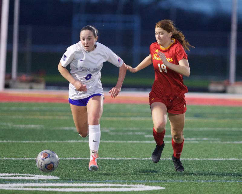 St. Charles North's Addyson Priess races for the ball against Batavia's Abigail Schmidt on Thursday, April 17,2025 in Batavia.