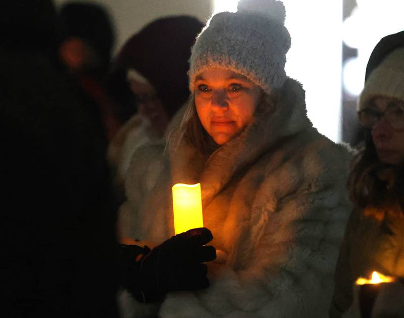 Attendees hold candles Monday, Jan. 26, 2026, during a vigil outside the DeKalb County Legislative Center in Sycamore after second shooting death in Minnesota involving ICE officers.