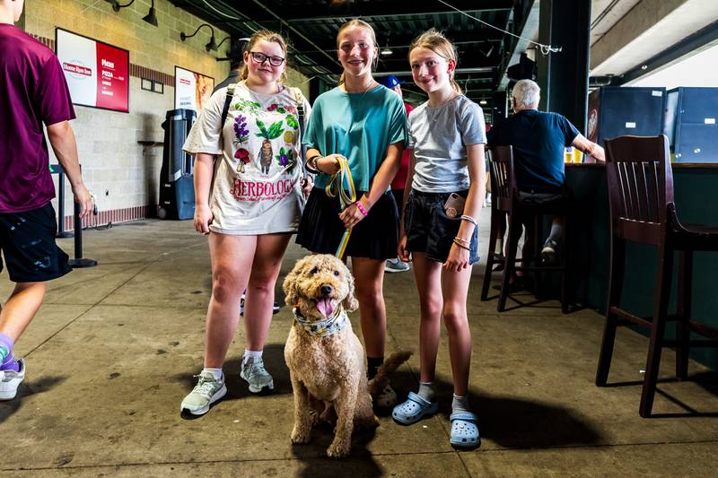 Plainfield residents Emily Cain, Kaya Franklin, and Lilly Gleason pose for a photo with Jelly inside Duly Heath and Care Field during the Joliet Slammers Dog Day event, presented by University of St. Francis, on Aug. 10, 2025.