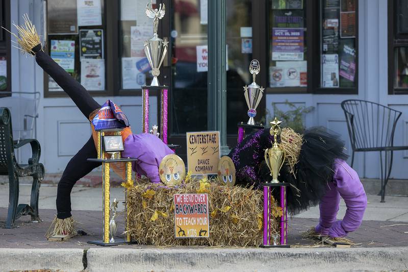 Scarecrows do backbends in a display Thursday, Oct. 16, 2025, in Dixon. The downtown was chock full of the straw stuffed critters on display for this weekend’s Scarecrow Fest.