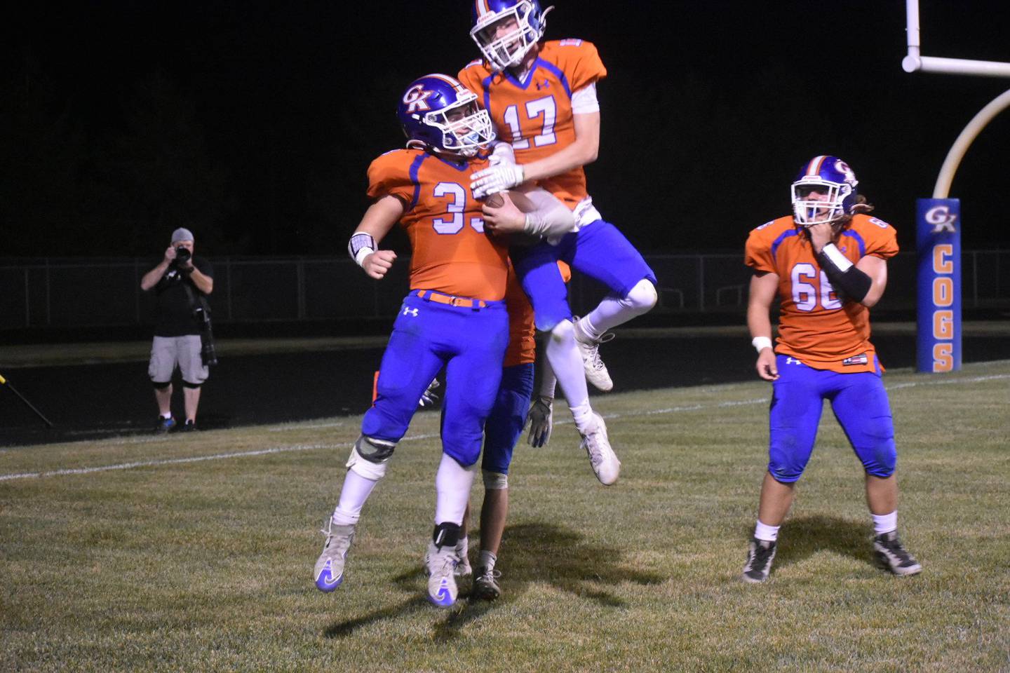 Genoa-Kingston running back Owen Zaccard (33) celebrates his touchdown with Blake Ides (17) and Carson Charnstrom (66) in the Cogs' 56-38 win over North Boone on Friday, Sept. 26, 2025, in Genoa.