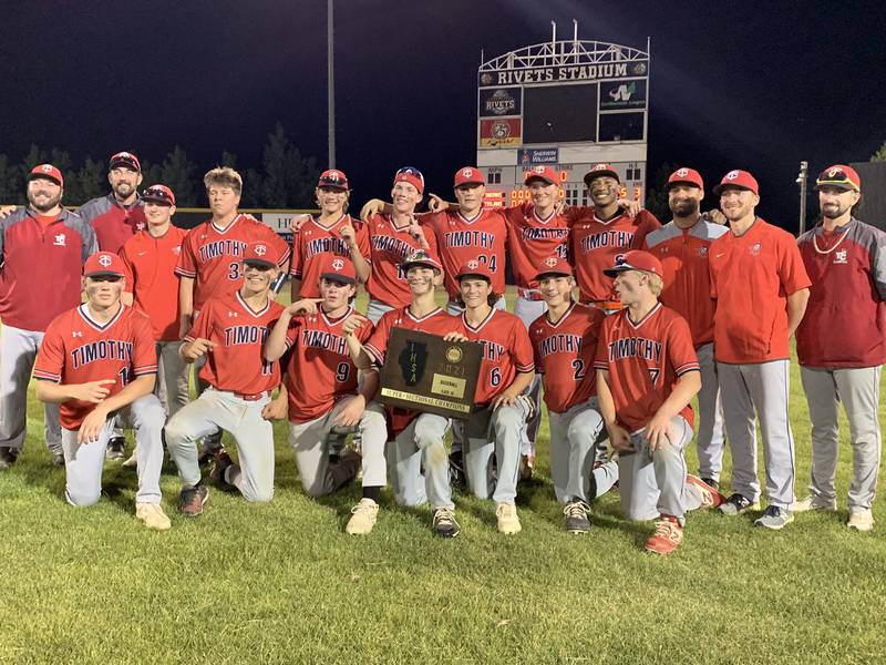 The Timothy Christian baseball team celebrates with its supersectional plaque after beating Winnebago 5-2 on Monday in Rockford.