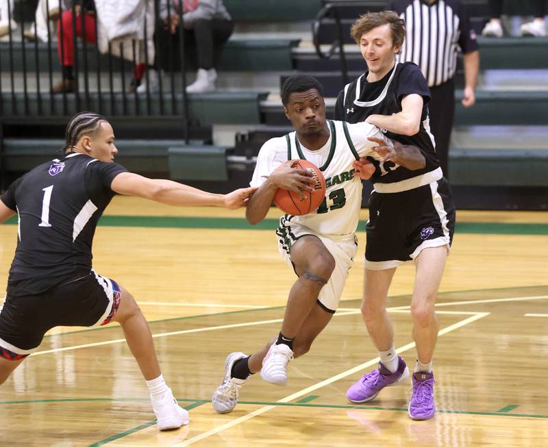 Kishwaukee College's Carron Gibson splits two Rockford University defenders on his way to the basket Thursday, Jan. 22, 2026, during their game at Kishwaukee College in Malta.