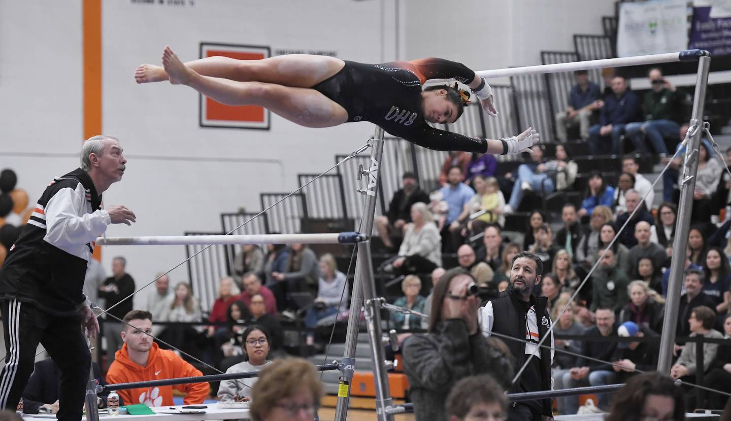 DeKalb’s Annabelle Simpson on the uneven bars at the Wheaton Warrenville South gymnastics sectional meet on Thursday, Feb. 8, 2024.