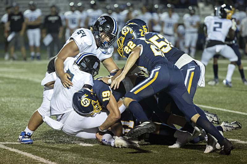 Sterling’s Mason Emin (19) leads the charge to tackle St. Francis’s TyVonn Ransom Friday, Sept. 1, 2023 at Sterling High School.