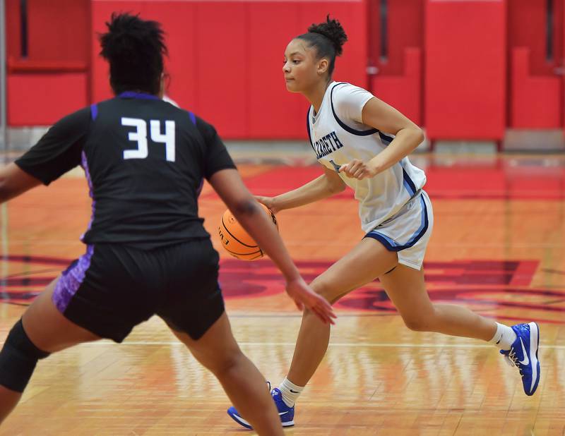 Nazareth’s Mia Gage drives past Downers Grove North’s Elizabeth Murphy (34) during the Class 4A Hinsdale Central Sectional final game on February 26, 2026 at Hinsdale Central High School in Hinsdale.