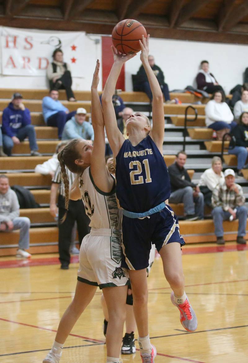 Marquette's Avery Durdan eyes the hoop as Midland's Ava Bade guards her during the Tri-County Conference Tournament third-place game on Thursday, Jan. 18, 2024 at Henry-Senachwine High School.