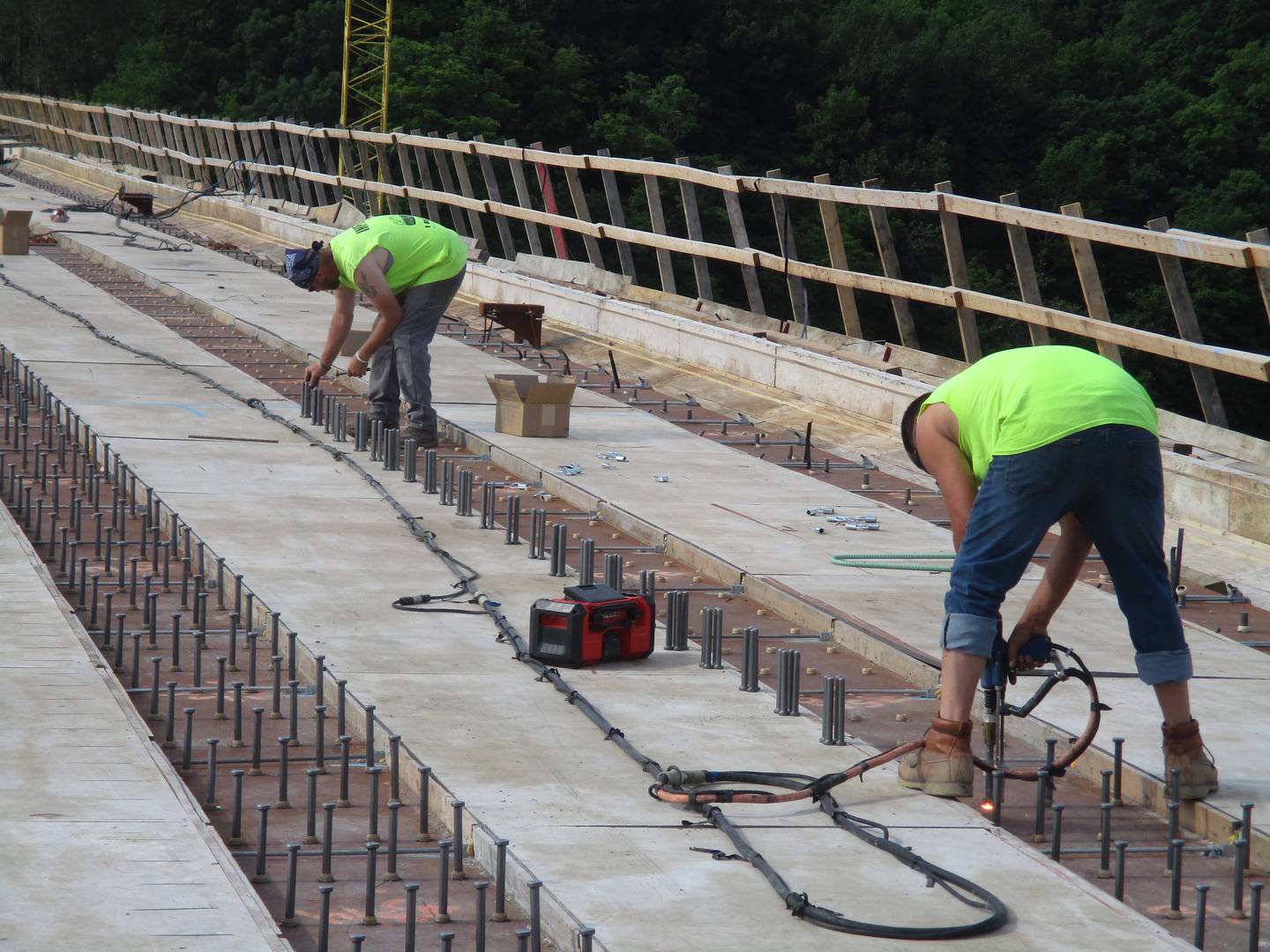 Construction workers weld steel studs atop the I-beams of the Eldamain Road bridge in preparation for pouring the concrete roadway deck. (Mark Foster -- mfoster@shawmedia.com)