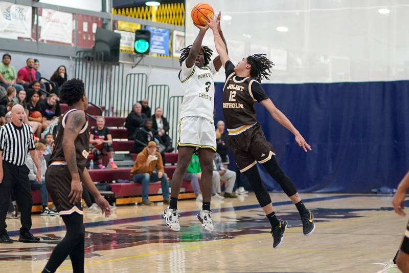 Yorkville Christian's Jayden Riley (3) shoots a three pointer against Joliet Catholic's Jeremy Sterrett jr (12) during a basketball game at Yorkville Christian High School on Monday, January 13, 2025.