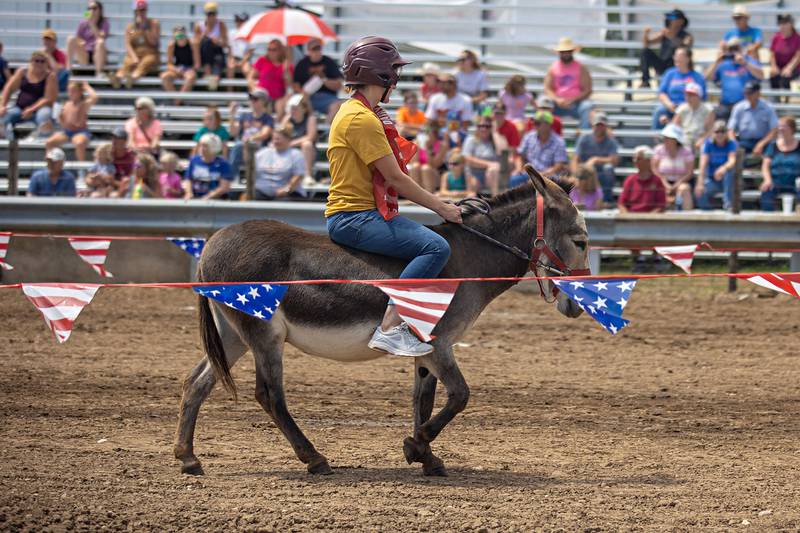Aubrey Setchell of Dixon kicks her donkey into high gear Sunday, July 31, 2022 during the first ever donkey races at the Lee County 4H fair. Setchell took the win in her heat.