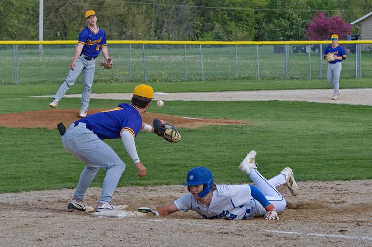 Newman's Garet Wolfe dives back in at first base on a pickoff attempt against Sherrard on Friday, May 2, 2025 in Sterling.