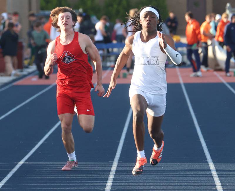 Ottawa's Brayden Brewer (left) and Joliet Catholic's Craig Peacock, the eventual champion, compete in the 100-meter dash during the Class 2A Pontiac Sectional on Wednesday, May 20, 2026, in Pontiac.
