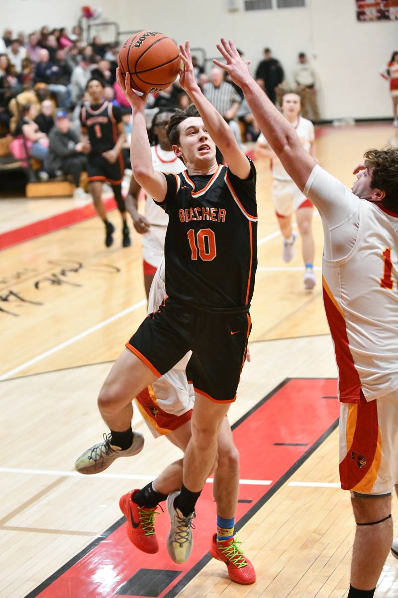 Beecher's Dominick DeFrank goes for a layup under pressure from St. Anne's Brandon Schoth on Friday, Feb. 14, 2025, during the Cardinals' 70-38 victory over Beecher in the River Valley Conference championship.