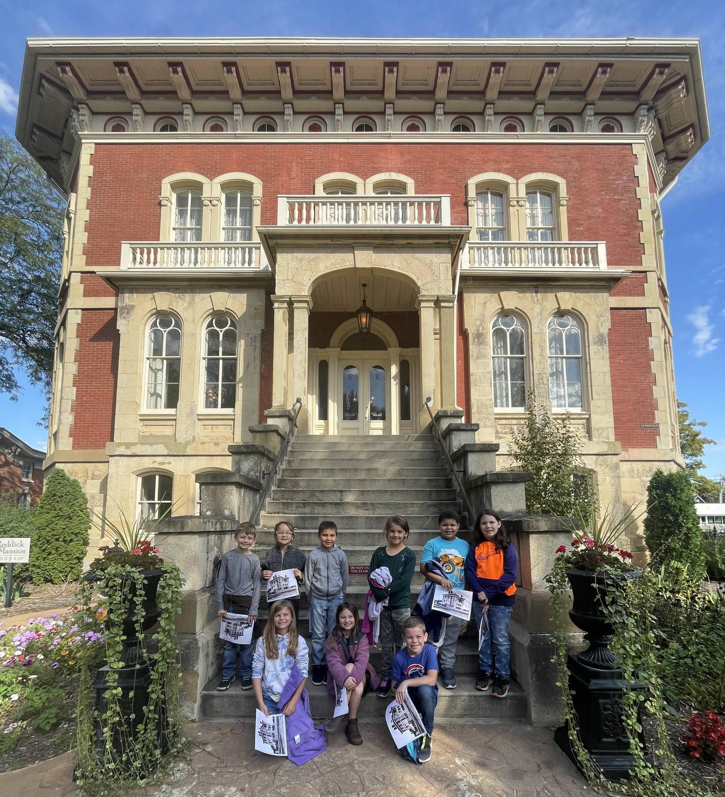 Samantha Carlson's second grade class from Grand Ridge Grade School poses on the outside stairway of the Reddick Mansion in Ottawa.