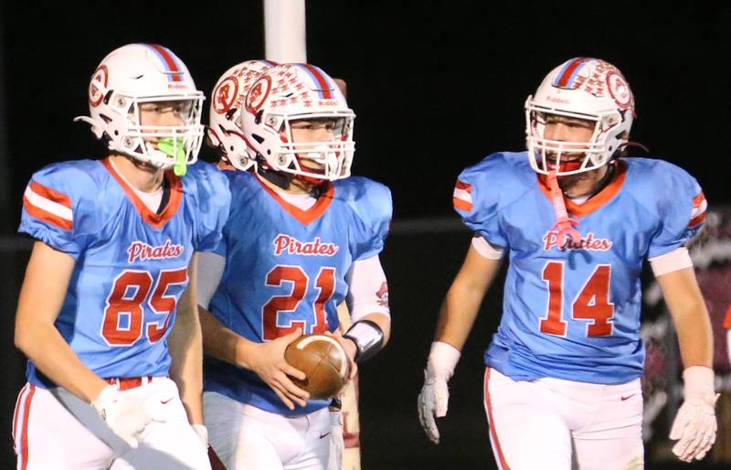 Ottawa players (from left) Dane Carretto, Wes Weatherford and Archer Cechowiz run back to the sideline after scoring a touchdown against Granite City on Friday, Oct. 24, 2025 on Kingman Field at Ottawa High School.